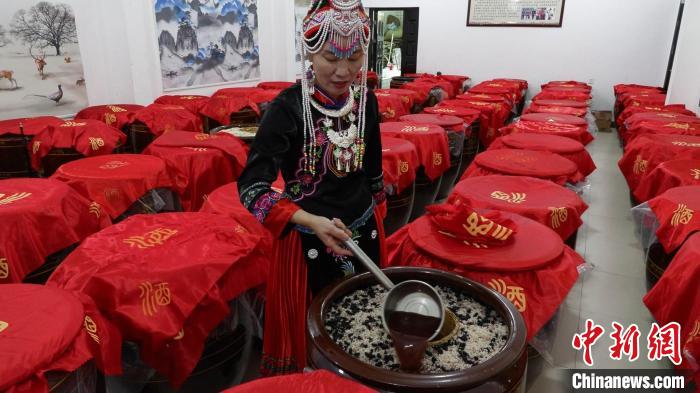 圖為藍春花在酒廠查看最新釀造的米酒?！∮浾呷A山 攝